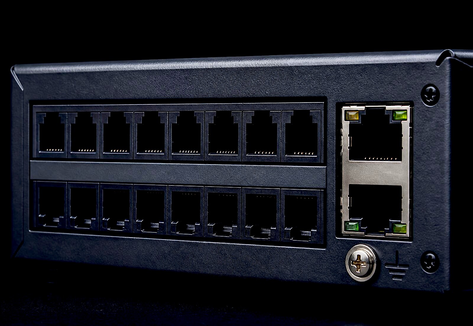 Macro detail of the rear port block: RJ11 FXS and FXO sockets, gigabit Ethernet and grounding point