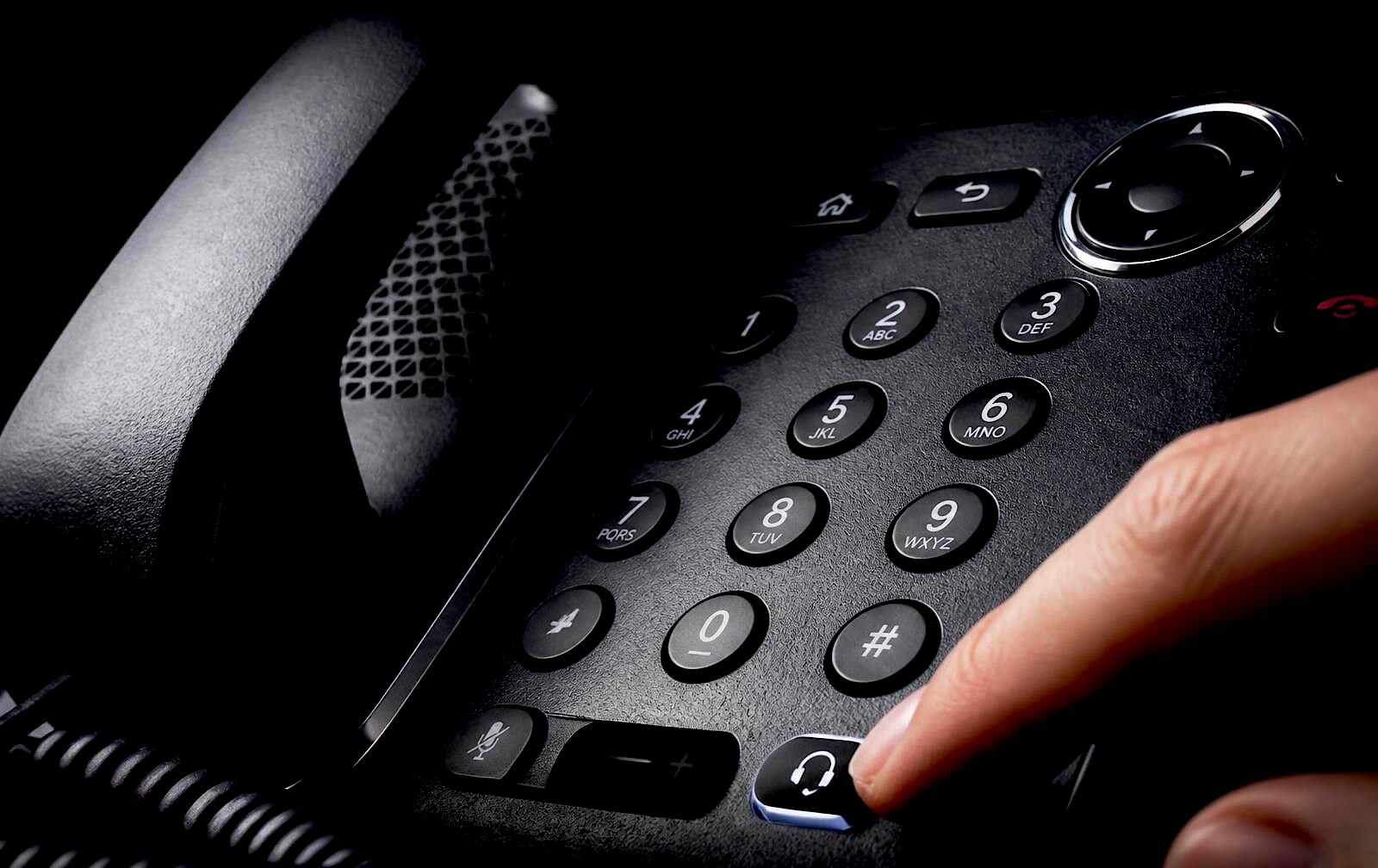 Close crop of a Xorcom UC series IP desk phone showing the display, keypad and programmable keys