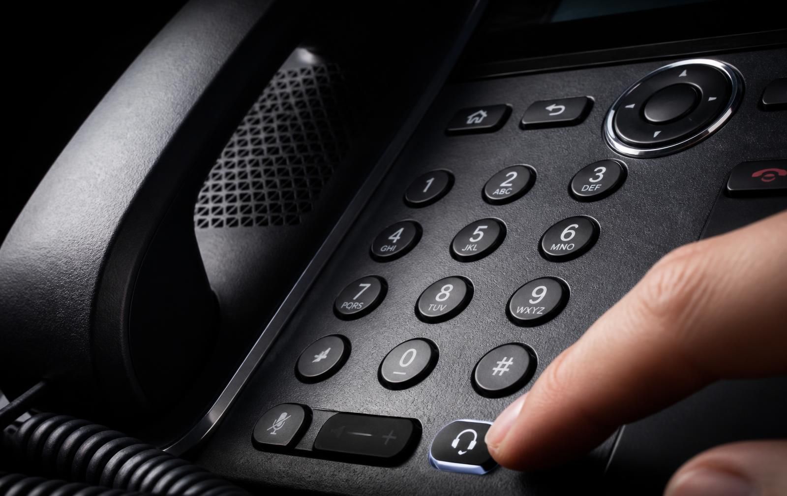 Close crop of a Xorcom UC series IP desk phone showing the display, keypad and programmable keys